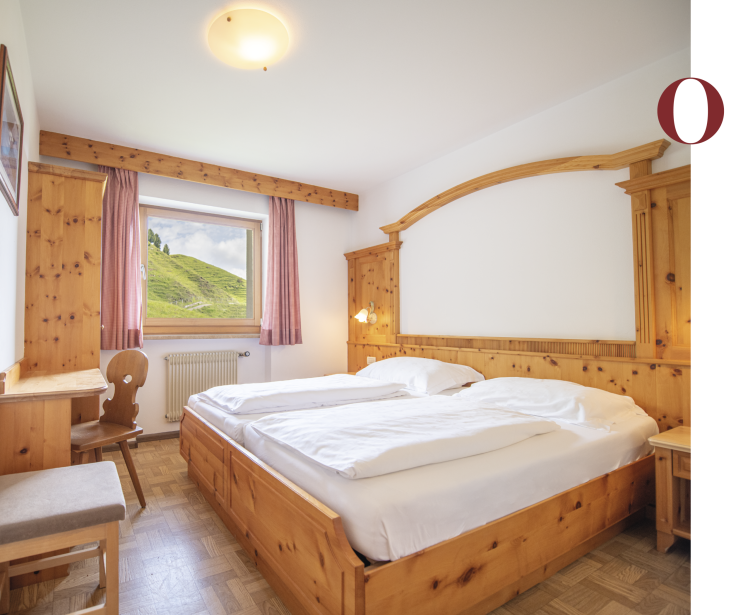 Molignon Schutzhaus Seiser Alm | high comfort and tranquillity on the Seiser Alm The picture shows a room in the Molignon refuge. It is a simple room with old wood.